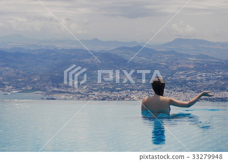 Young female in the pool on the roof in Greece Young female in the pool on the roof in Greece 33279948
