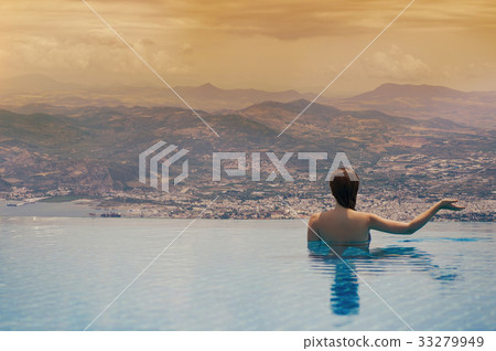 Young female in the pool on the roof in Greece Young female in the pool on the roof in Greece 33279949