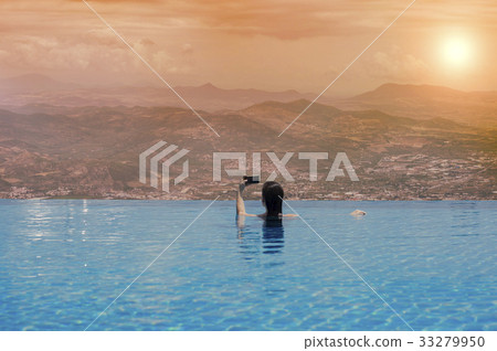 Young female in the pool on the roof in Greece Young female in the pool on the roof in Greece 33279950