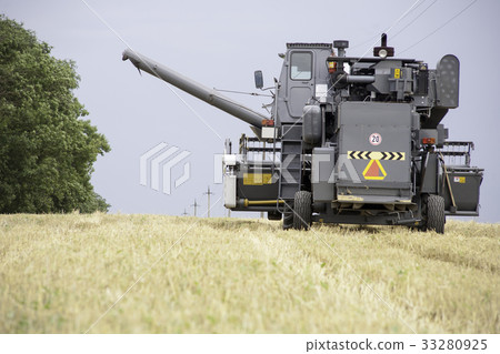 combine harvester working on a wheat field. combine harvester working on a wheat field. 33280925
