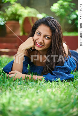 pretty young girl laying on grass 33285073