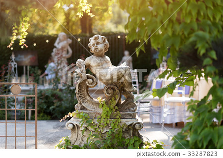 Cupid sculpture in the garden, cute cupid statue 33287823