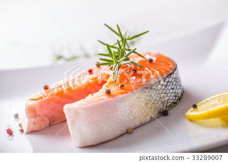 Salmon. Raw salmon steak with rosemary and lemon. Salmon. Raw salmon steak with rosemary and lemon. 33289007