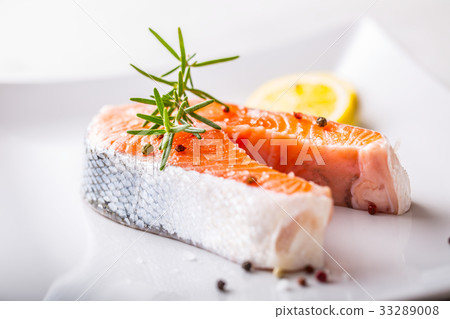 Salmon. Raw salmon steak with rosemary and lemon. Salmon. Raw salmon steak with rosemary and lemon. 33289008