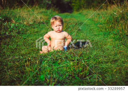 The child is sitting on the grass The child is sitting on the grass 33289957
