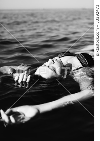 Woman floating on water 33292473