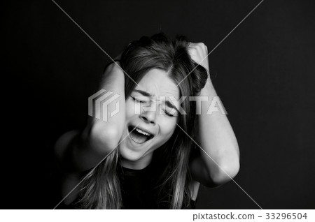 Beautiful girl with long hair yells. Black Beautiful girl with long hair yells. Black 33296504