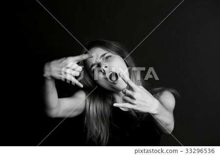Young beautiful girl. Sign rock n roll fingers. 33296536