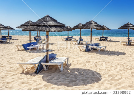 Umbrellas and sunbeds on the southern beach of the Umbrellas and sunbeds on the southern beach of the 33298992