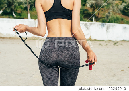 Slim girl in sportswear on the beach 33299040