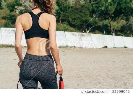 Sports brunette girl in sportswear on the beach 33299041