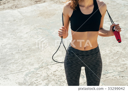 Cropped image of a girl in a bra and sweat pants 33299042