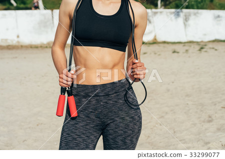 Cropped image of a slim woman in sportswear Cropped image of a slim woman in sportswear 33299077