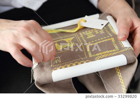 The process of working on a piece of embroidery 33299820