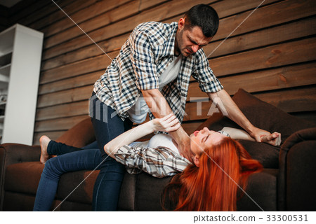 Man strangles woman with a tie, domestic violence 33300531