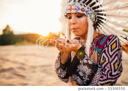 Female American Indian play with sand on sunset 33300550