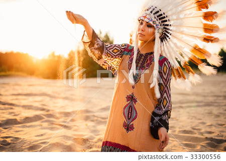 Woman in suit of American Indian on sunset Woman in suit of American Indian on sunset 33300556