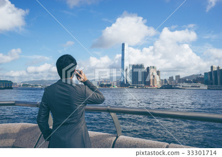 Young asian business man using his smartphone Young asian business man using his smartphone 33301714