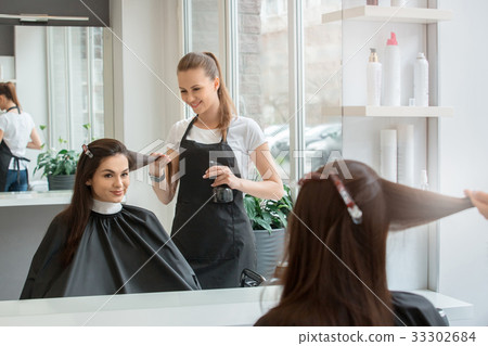 Young women sitting in beauty hair salon style 33302684