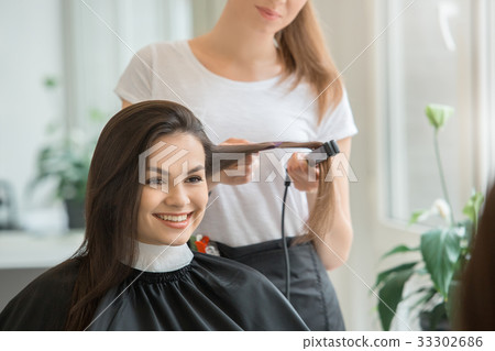 Young women sitting in beauty hair salon style 33302686