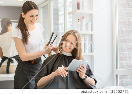 Young women sitting in beauty hair salon style Young women sitting in beauty hair salon style 33302771