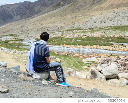 Tourist looking at mountain scenery Tourist looking at mountain scenery 33304034