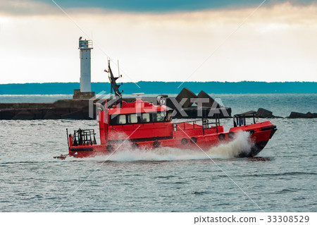 Red pilot ship sailing to Baltic sea 33308529