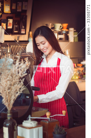 Female Barista wear red apron strips with smiling Female Barista wear red apron strips with smiling 33308771
