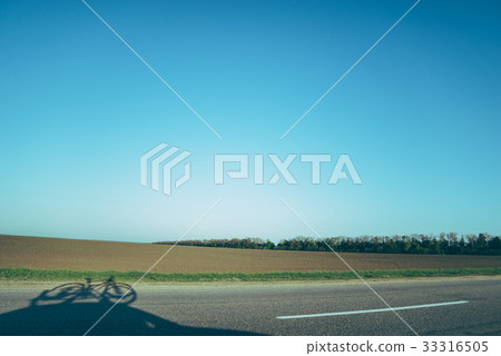 road with shadow of the car with bicycle on the road with shadow of the car with bicycle on the 33316505