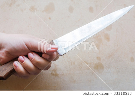 Woman holds knife in hands Woman holds knife in hands 33318553