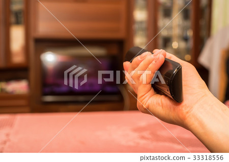 Hand holds TV remote control Hand holds TV remote control 33318556