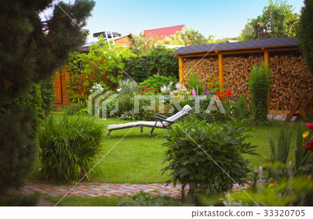 beautiful summer garden with coushion chaise lounge fire wood beautiful summer garden with coushion chaise lounge fire wood 33320705