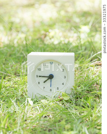 Square simple white clock on the grass 7:45 Square simple white clock on the grass 7:45 33321975