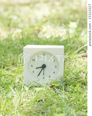 Square simple white clock on the grass 8:35 Square simple white clock on the grass 8:35 33322027