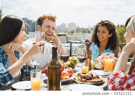 Group of friends having barbecue party on the roof 33322151