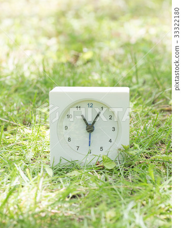 Square simple white clock on the grass 11:05 Square simple white clock on the grass 11:05 33322180