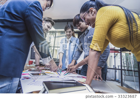 Group Of Asian and Multiethnic Business people with casual suit working and brainstorming together in the modern Office, people business group concept Group Of Asian and Multiethnic Business people with casual suit working and brainstorming together in the modern Office, people business group concept 33323687