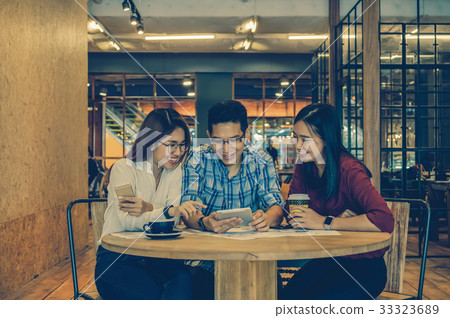 Group Of Asian Business people with casual suit brainstorm in relax action In the modern coffee shop, business group concept Group Of Asian Business people with casual suit brainstorm in relax action In the modern coffee shop, business group concept 33323689