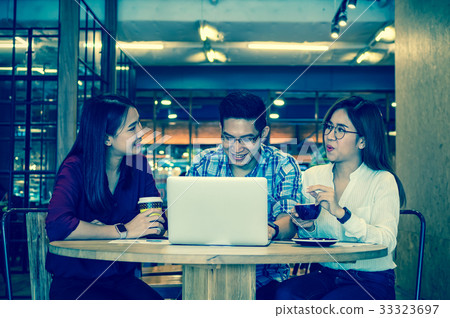 Group Of Asian Business people with casual suit brainstorm in relax action In the modern coffee shop, business group concept Group Of Asian Business people with casual suit brainstorm in relax action In the modern coffee shop, business group concept 33323697