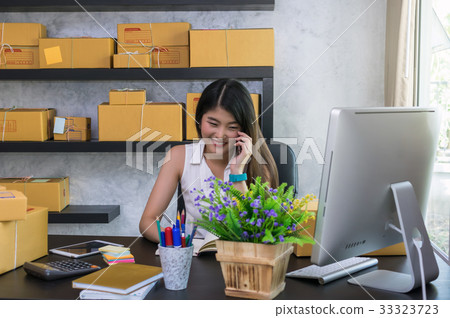 Young asian teenager owner business woman work at home for online shopping, calling and writing the order of product with office equipment, entrepreneur and alpha generation life style concept 33323723