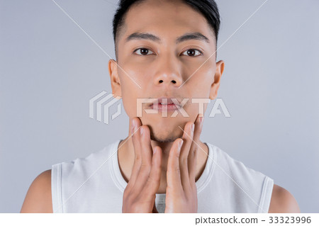 the man is touching both hands on his face the man is touching both hands on his face 33323996