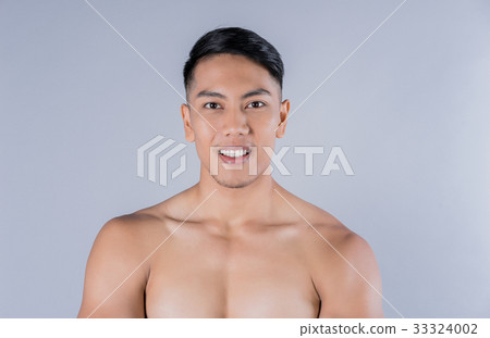 portrait of a young man smiling on gray background portrait of a young man smiling on gray background 33324002