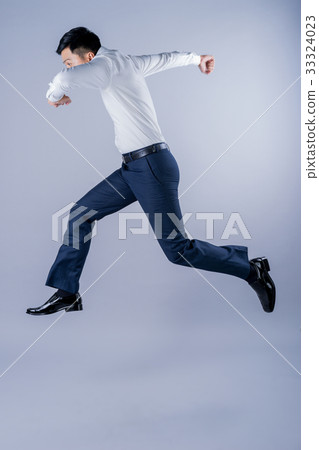 a photo of asian worker jumping on gray background 33324023