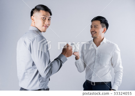 Two handsome men are drinking coffee and chatting together 33324055