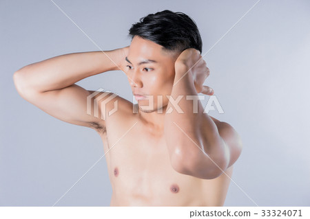 Portrait of fitness man posing on gray background Portrait of fitness man posing on gray background 33324071