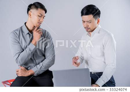 Two business men are discussing on gray background Two business men are discussing on gray background 33324074