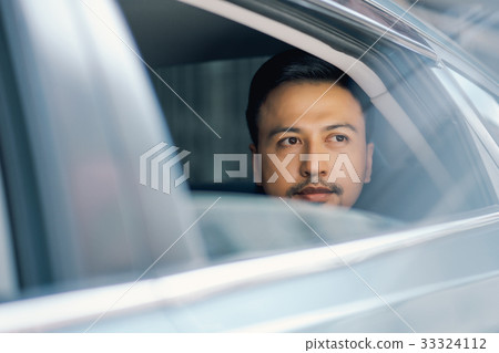a man in car is looking at something a man in car is looking at something 33324112