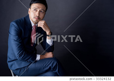 A businessman is sitting and thinking about something 33324132