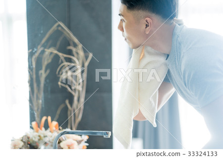 A man is using his towel in the bathroom A man is using his towel in the bathroom 33324133