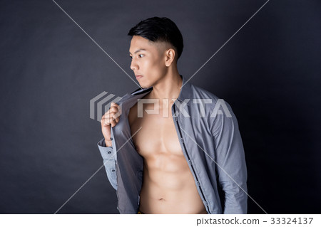 An asian man is posing photo with strong muscle and his shirt An asian man is posing photo with strong muscle and his shirt 33324137